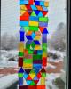 Photo of stained glass suncatcher craft sample hanging in front of window