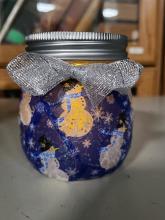 Photo of Holiday Luminary Craft, tissue paper over a glass jar with a fake candle inside